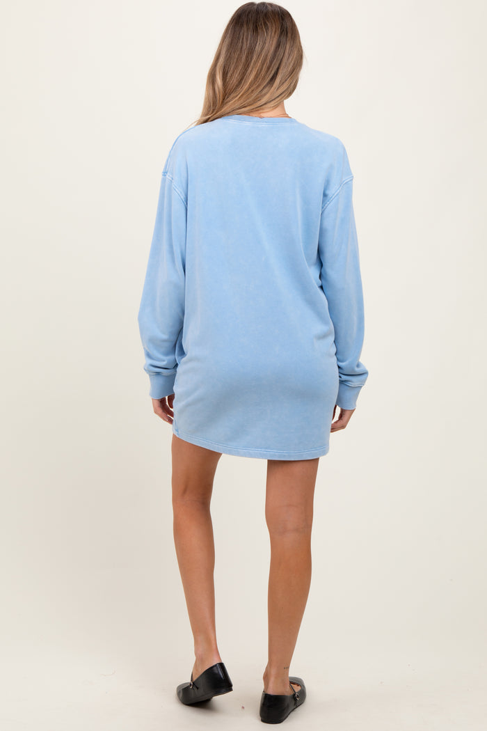 woman wearing a light blue maternity sweatshirt dress, showing a relaxed fit and long sleeves from the back