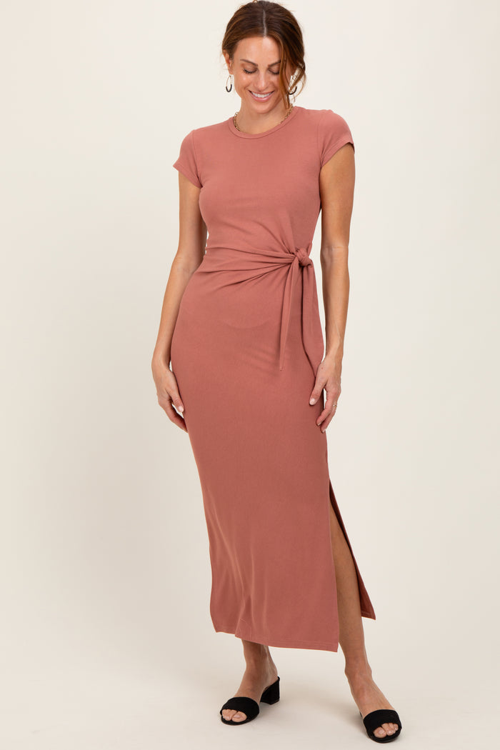 woman wearing a rose pink short sleeve maxi dress with a side tie and a thigh-high slit