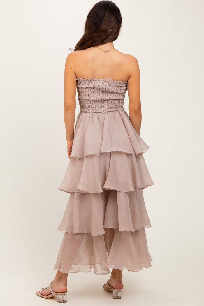 woman wearing a tiered mauve strapless dress with a smocked bodice and ruffled layers