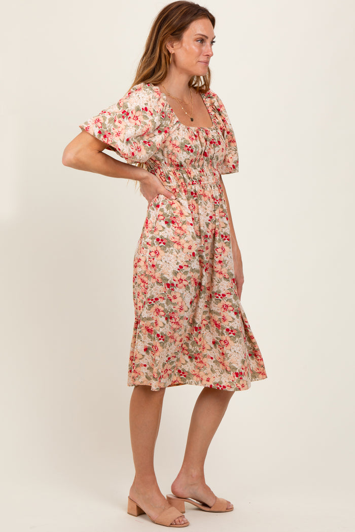 woman wearing a floral print midi dress with puff sleeves and a fitted waist in a side pose