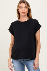 woman wearing a black short sleeve maternity top with rolled sleeves and a slight relax fit, showing her baby bump