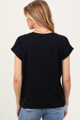 woman wearing a black maternity top with rolled sleeves and a relaxed fit, viewed from the back