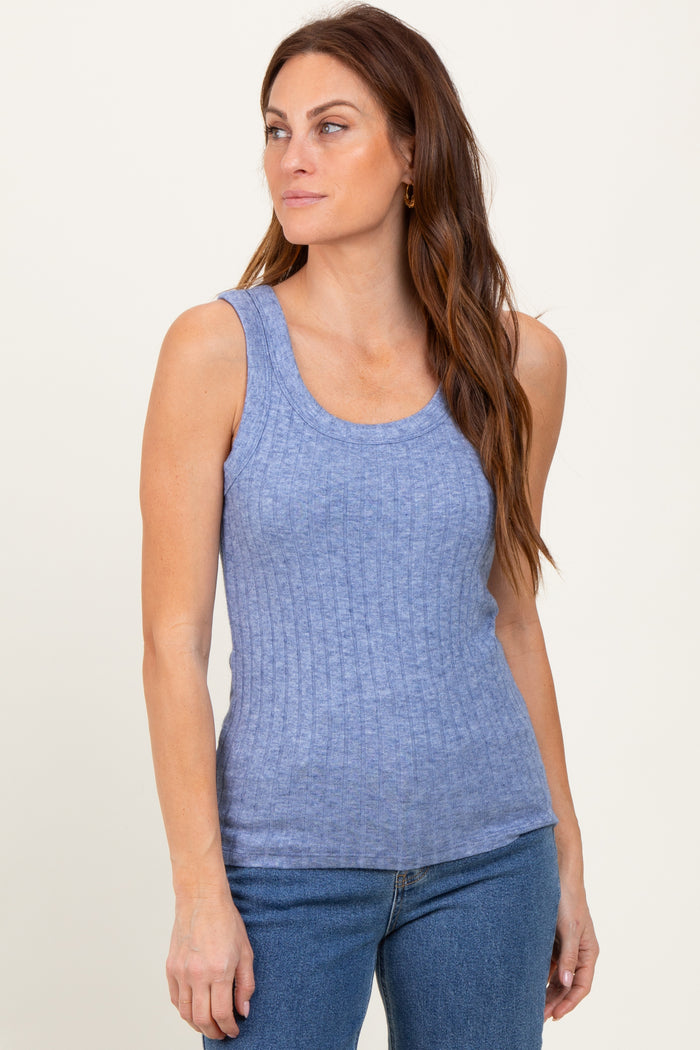 woman wearing a light blue ribbed tank top paired with blue jeans