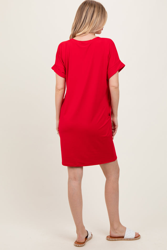 woman wearing a bright red short sleeve dress, standing with her back to the camera
