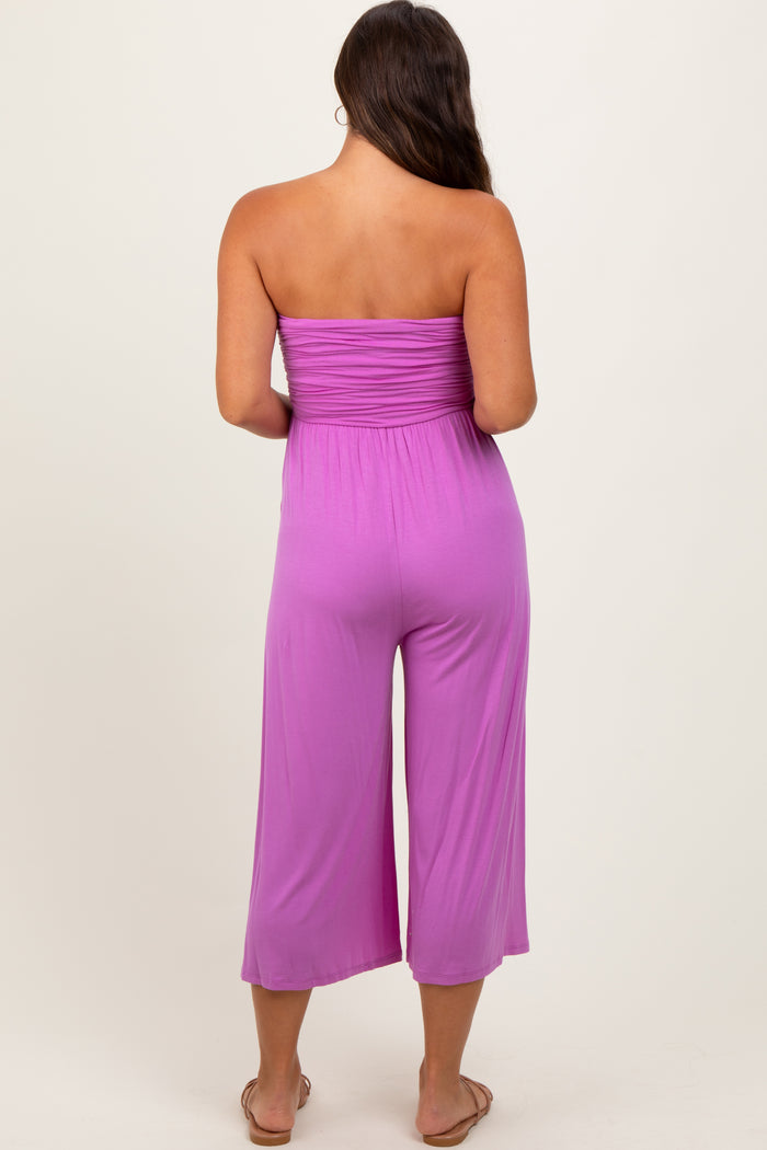 woman wearing a purple strapless maternity jumpsuit with a relaxed fit and cropped pants