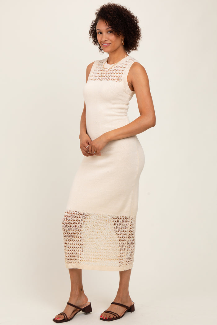 woman wearing a cream sleeveless knit midi dress with a crochet pattern and a fitted silhouette