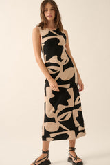 woman wearing a sleeveless black and beige patterned midi dress with a fitted silhouette