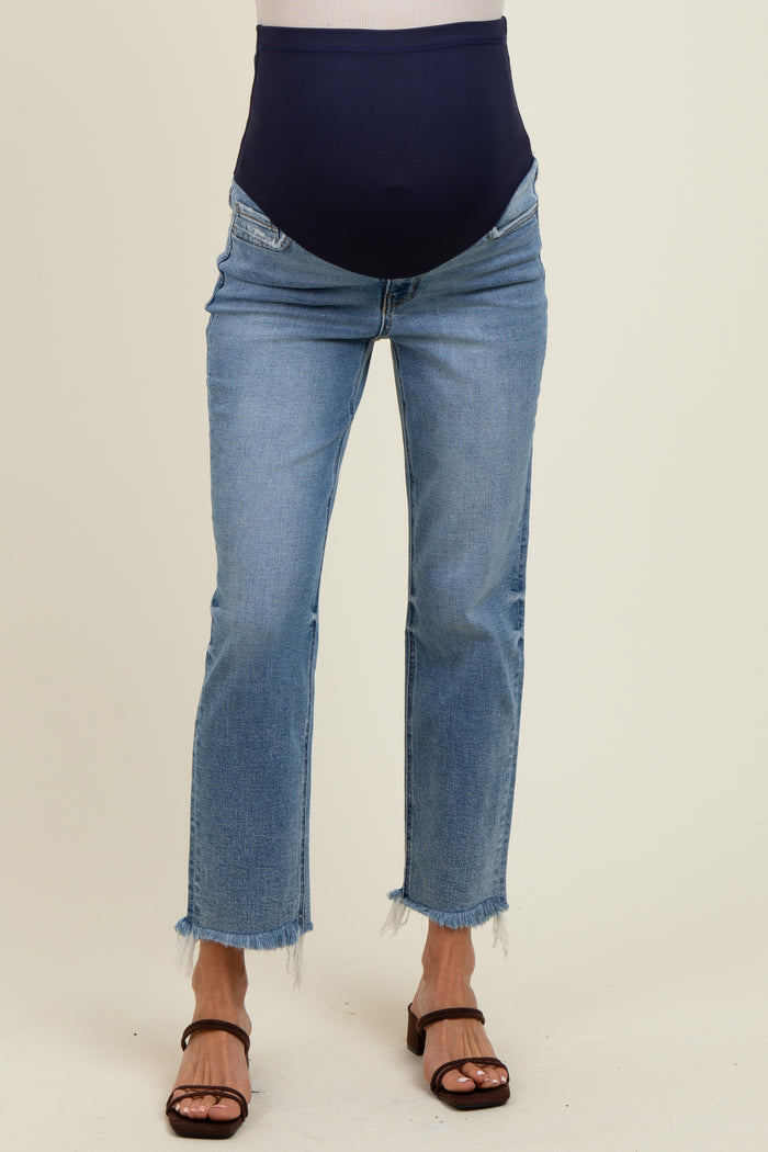 woman wearing light blue maternity jeans with a dark blue belly panel and frayed hems