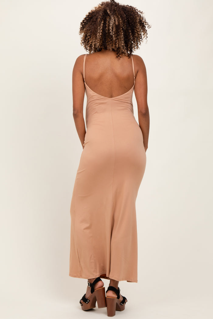 woman wearing a light brown maternity maxi dress with thin straps, viewed from the back