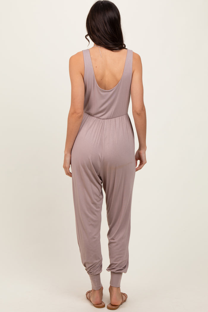 woman wearing a light mauve sleeveless jumpsuit with a low back and tapered legs