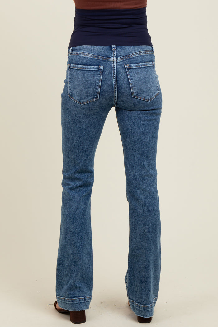 woman wearing blue maternity bootcut jeans seen from the back