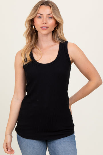 woman wearing a black ribbed tank top paired with light blue jeans