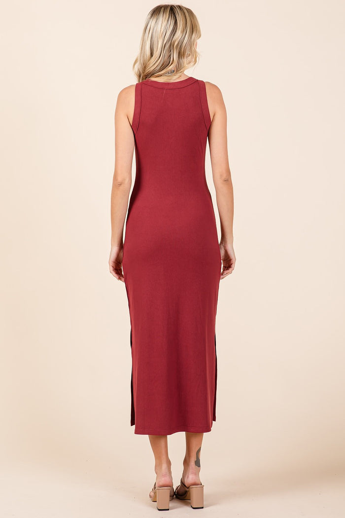 woman wearing a burgundy sleeveless maxi dress with side slits, showing the back view