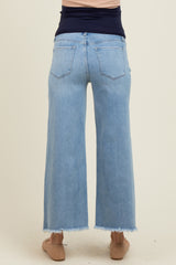 woman wearing light blue maternity wide-leg jeans with frayed hem, showing the back view