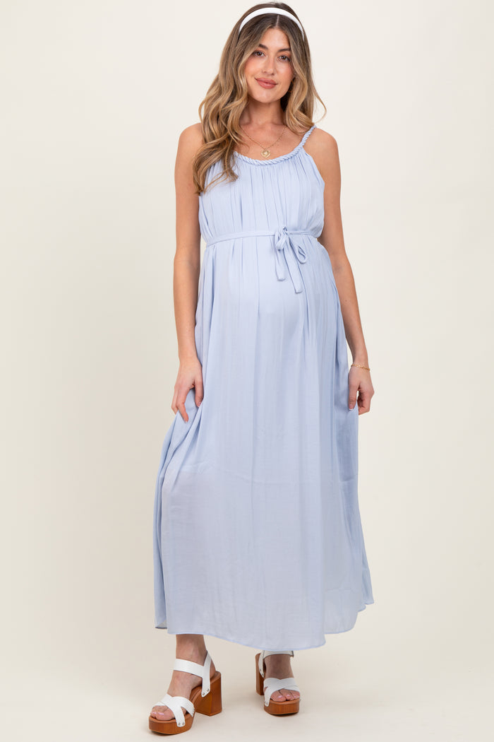 woman wearing a light blue maternity maxi dress with a tie waist and showing her baby bump