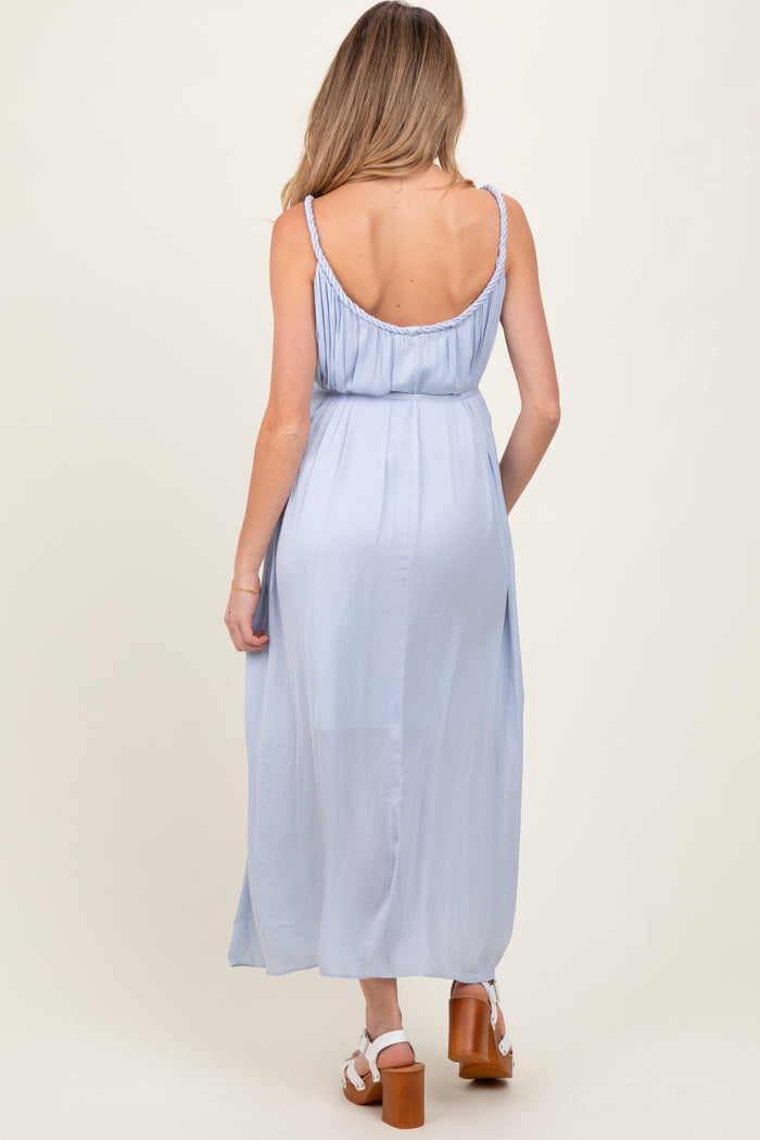 woman wearing a light blue maternity maxi dress with adjustable straps and a flowing silhouette