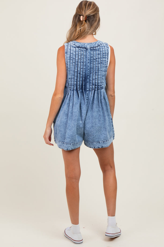 woman wearing a denim maternity romper with pleated back detailing, shown from the back