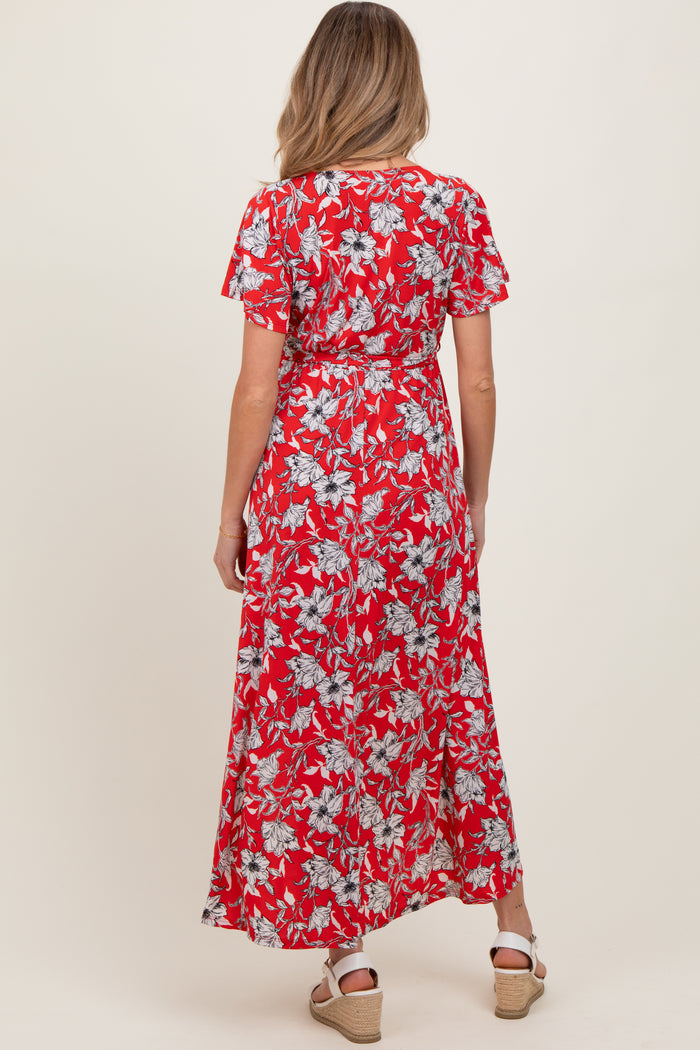 woman wearing a red floral maternity maxi dress, featuring short sleeves and a fitted waist, seen from the back