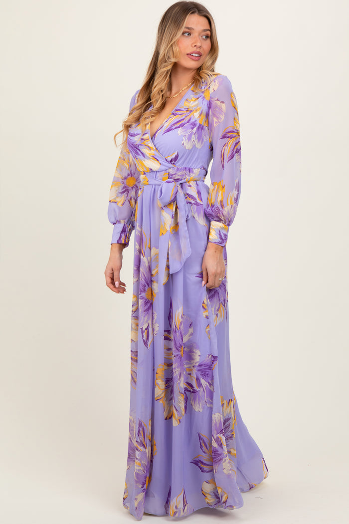 woman wearing a lavender floral maxi dress with long sleeves and a tie waist detail