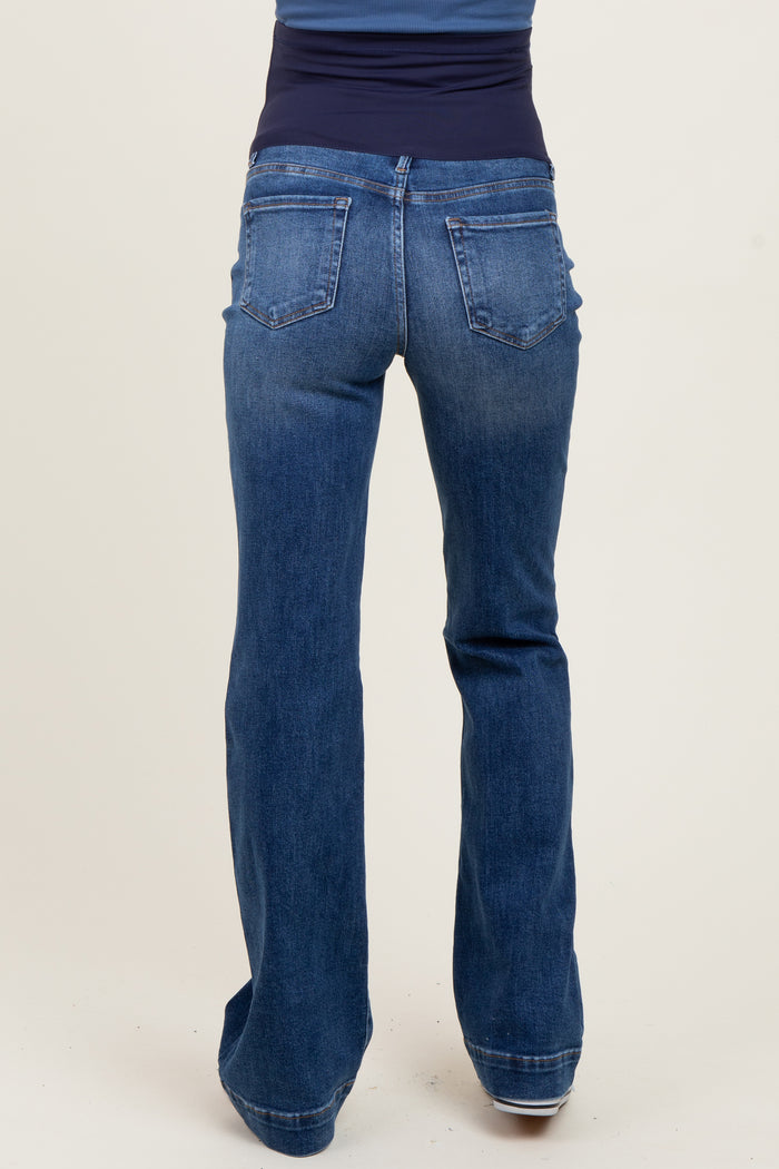 woman wearing dark blue maternity bootcut jeans with a supportive belly band, viewed from the back
