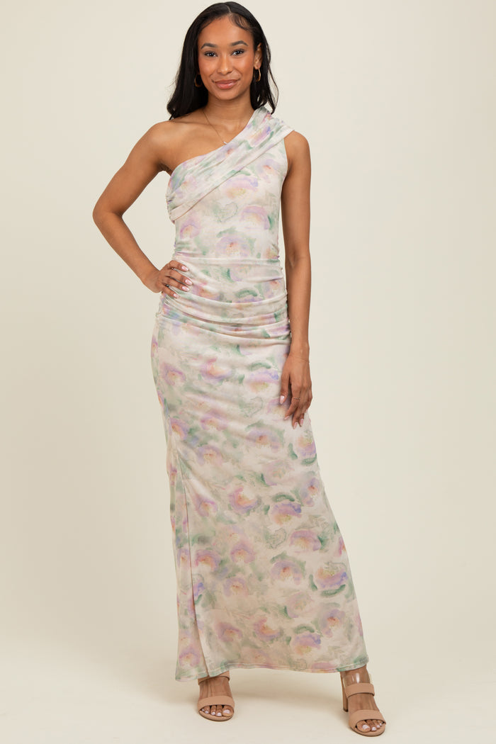 woman wearing a one-shoulder pastel printed maxi dress with ruching details and posing confidently