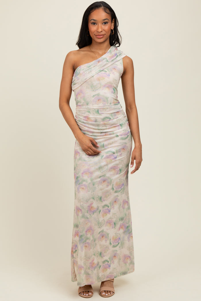 woman wearing a floral print one-shoulder maxi dress with ruching details