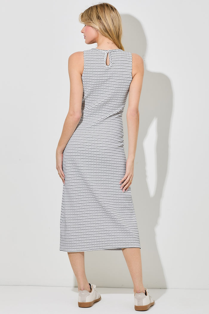 woman wearing a black and white checkered midi dress with a keyhole detail at the back