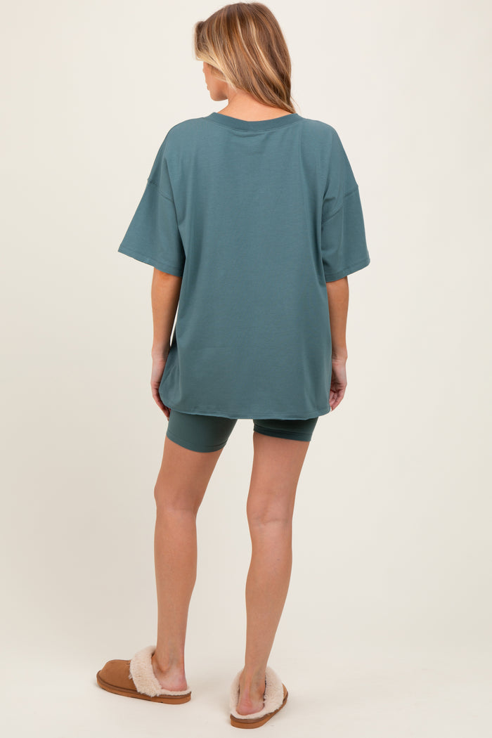 woman wearing a sea green oversized t-shirt with matching shorts, showcasing comfortable maternity loungewear.