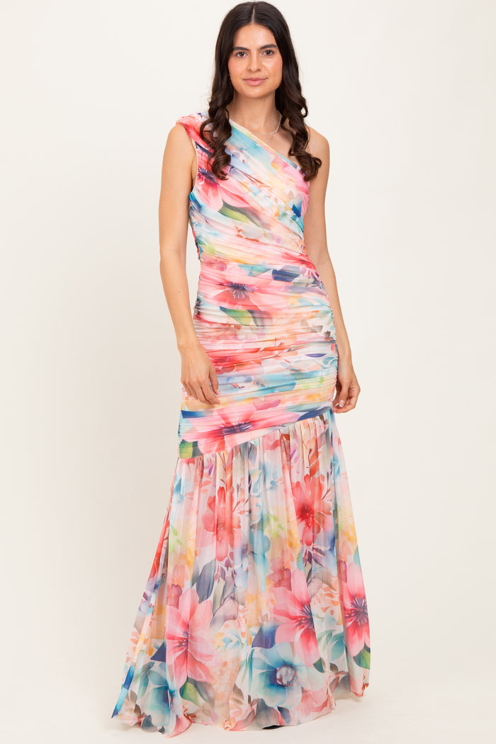 woman wearing a colorful floral maxi dress with a fitted top and flared skirt