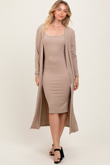 woman wearing a beige ribbed midi dress with a matching long cardigan and black heeled sandals