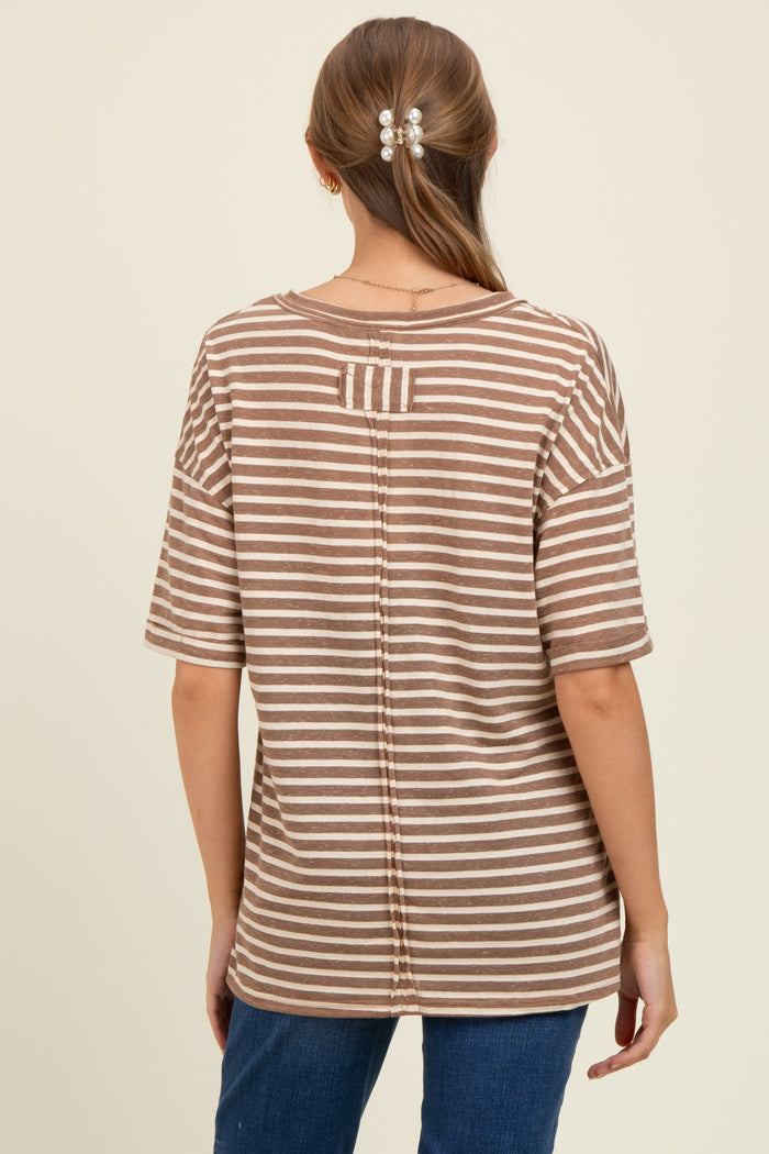 woman wearing a brown and cream striped maternity top with a back button detail