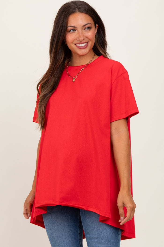 woman wearing a bright red oversized maternity t-shirt with a curved hem and a baby bump visible