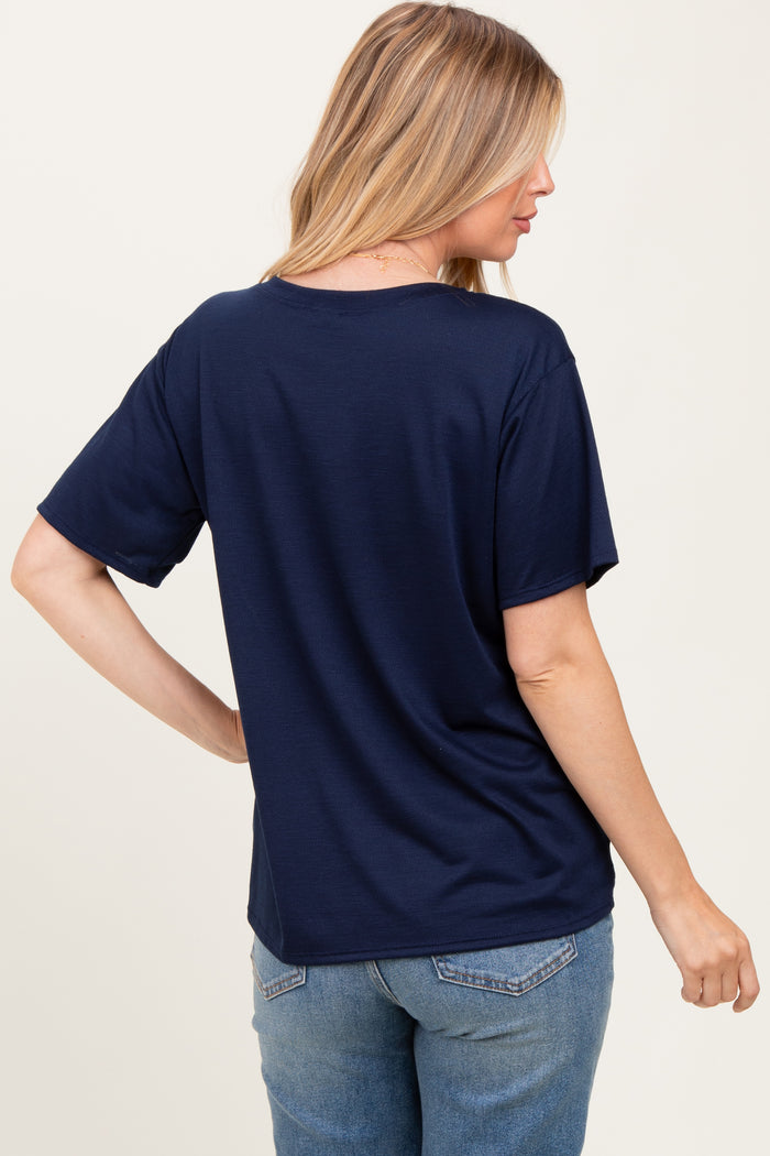 woman wearing a navy blue short sleeve maternity top, showing the back view with relaxed fit
