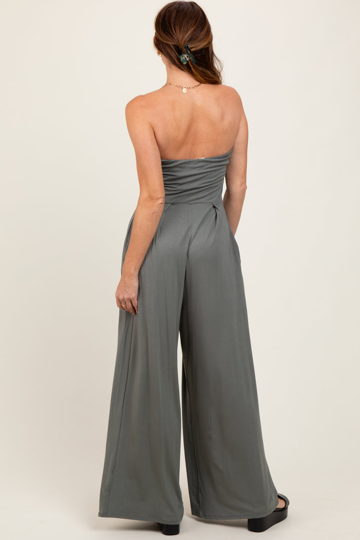 woman wearing a backless olive green strapless jumpsuit with wide-leg pants