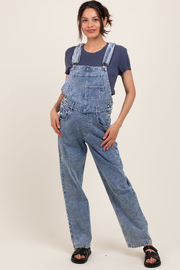 woman wearing a blue denim maternity overall with a relaxed fit and a dark blue t-shirt underneath