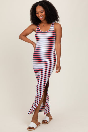 woman wearing a navy and white striped maxi dress with a thigh-high slit and smiling while walking