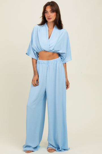 woman wearing a light blue cropped top and matching wide-leg pants