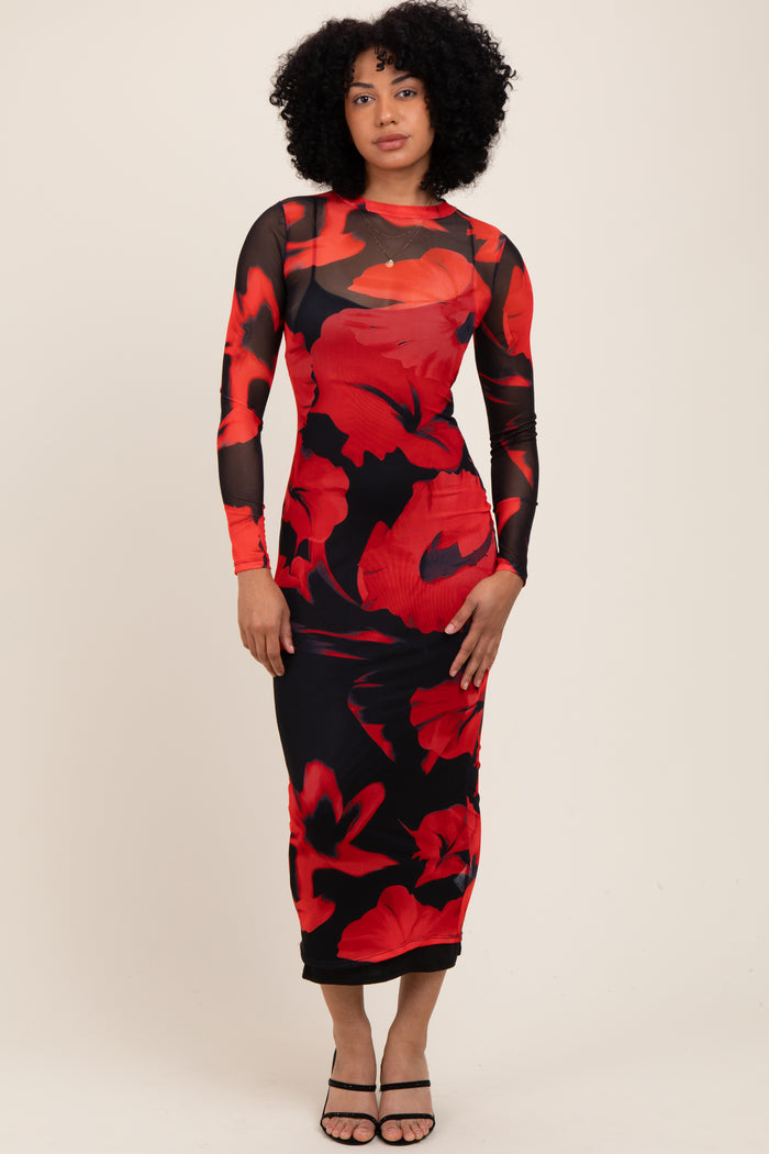 woman wearing a long sleeve black dress with a red floral print and a fitted silhouette