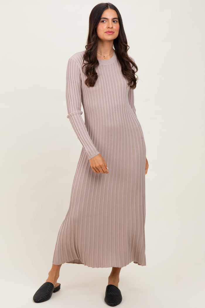 woman wearing a light taupe long sleeve ribbed maxi dress and black slip-on shoes