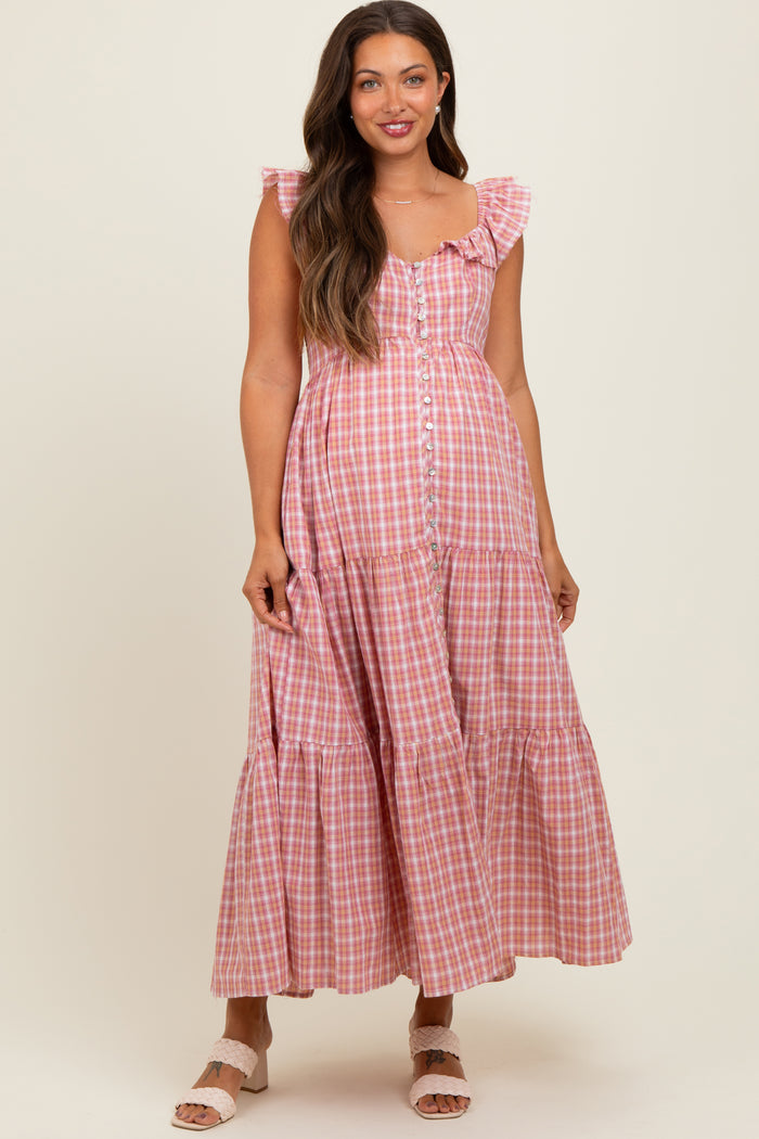 woman wearing a pink and white gingham maternity maxi dress with ruffles and buttons