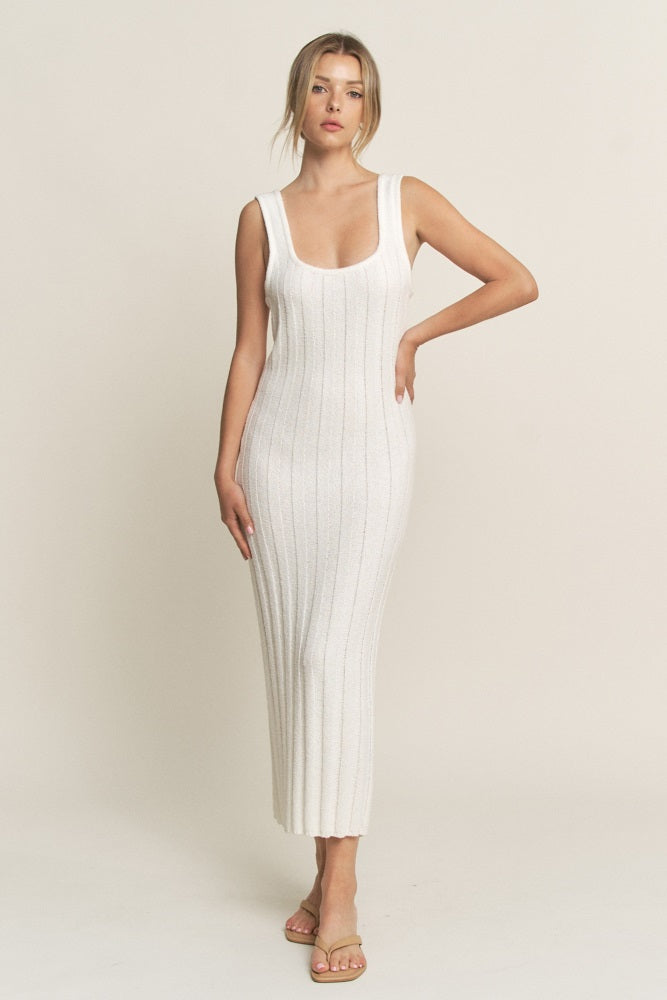 woman wearing a white ribbed knit sleeveless maxi dress with a scoop neckline and a fitted silhouette