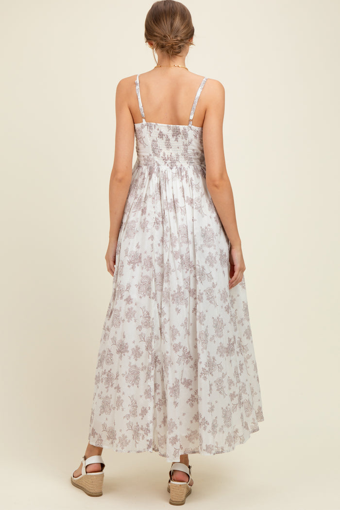 woman wearing a floral print maternity maxi dress with adjustable straps and a smocked back