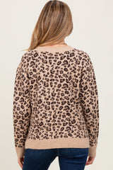 woman wearing a leopard print maternity sweater, with a relaxed fit and ribbed hem, shown from the back