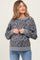 woman wearing a gray leopard print maternity sweater with long sleeves and a relaxed fit, showing her baby bump