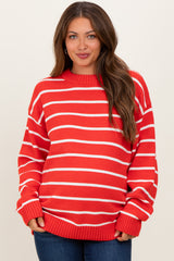 woman wearing a red and white striped maternity sweater with a relaxed fit and long sleeves