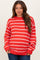 woman wearing a red and white striped maternity sweater with a relaxed fit and long sleeves