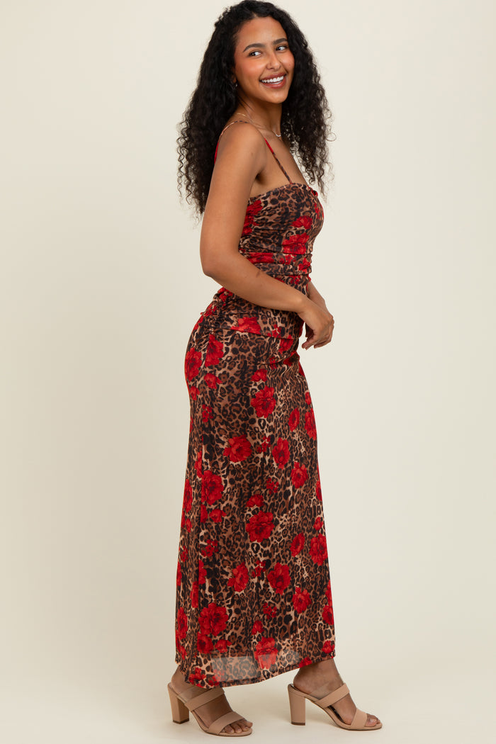 woman wearing a brown and red floral leopard print maxi dress with a fitted bodice and flowing skirt