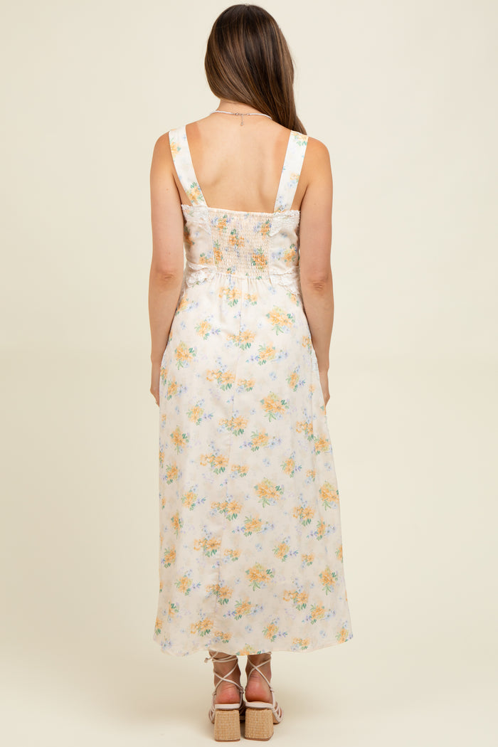 woman wearing a floral print maternity maxi dress with a smocked back, showcasing a comfortable fit