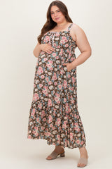 woman wearing a brown floral maternity maxi dress with a tiered skirt and pockets, showcasing her baby bump