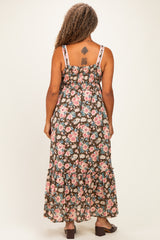 woman wearing a floral maxi dress with a smocked back and tiered ruffle hem, shown from the back